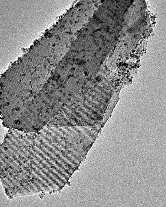 An image of a zeolite before having its atomic ordering (striations) being removed by the electron beam.