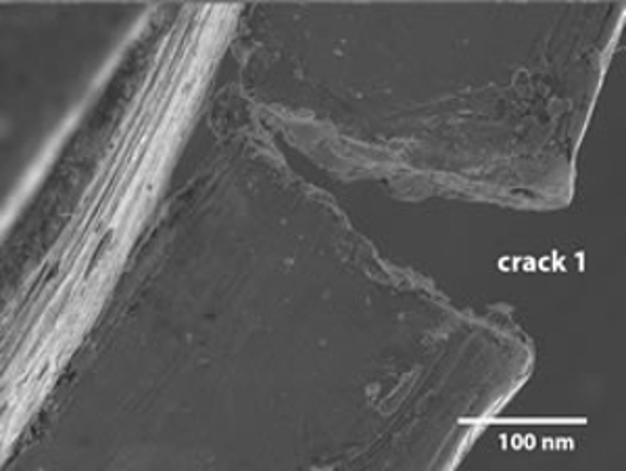 An image of the damaged High Tilt Retainer (HTR) showing the first crack magnified at 100 nm.